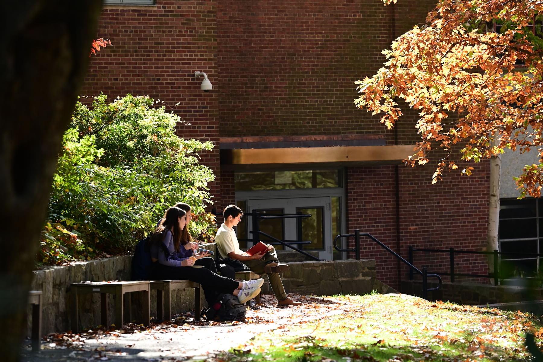 Ethical Culture Fieldston School Upper School students sit in the quad in the sun