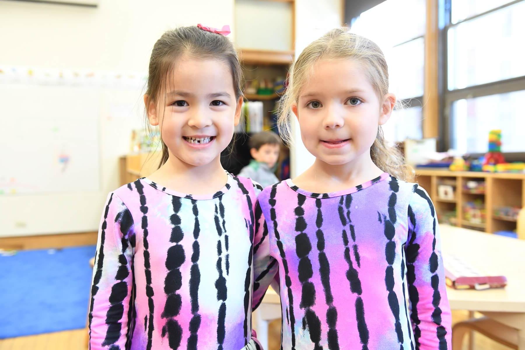 Ethical Culture Fieldston School students in matching shirts smile at the camera