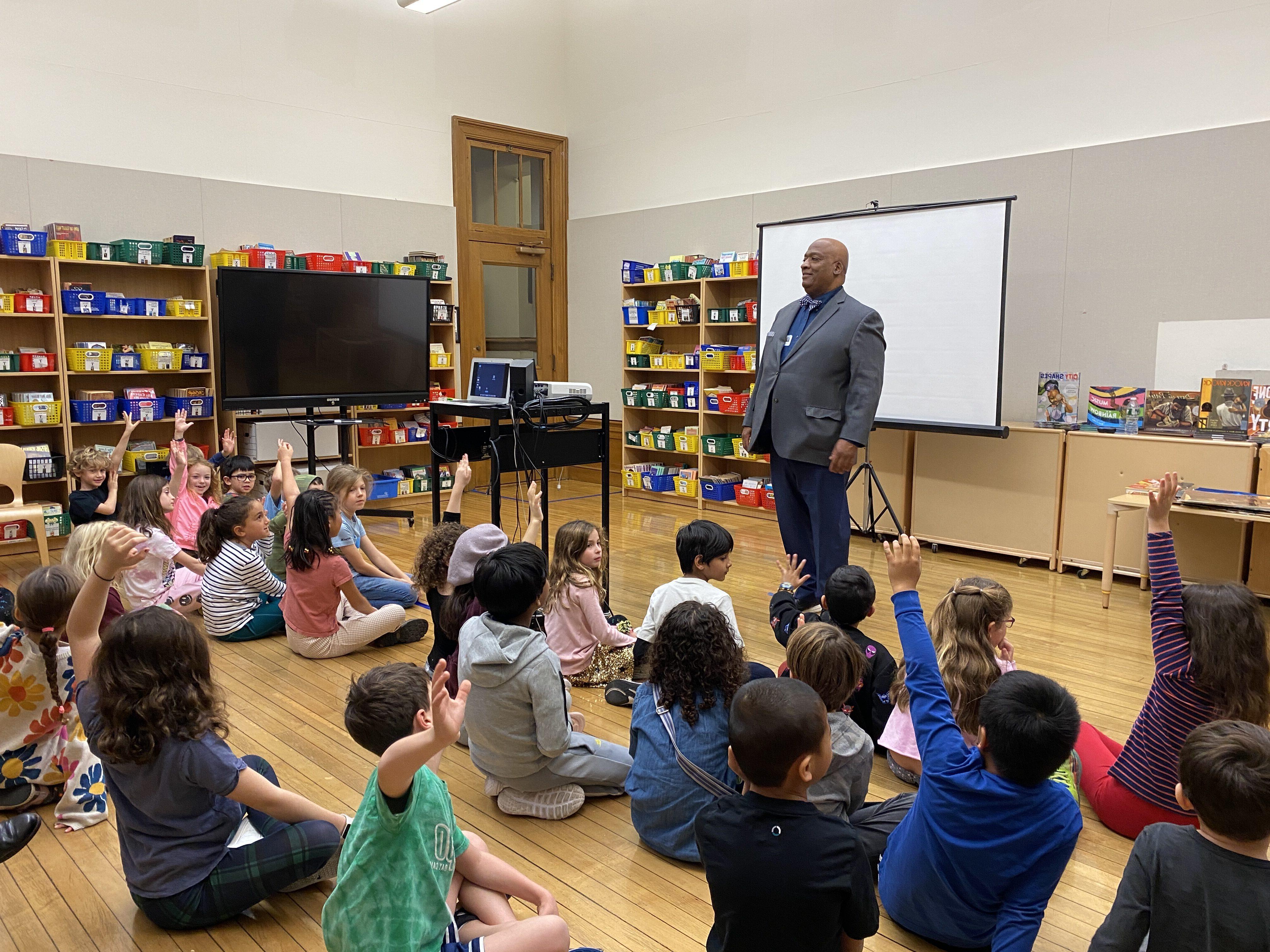 Bryan Collier in front of a class of 2nd Grade students at Ethical Culture