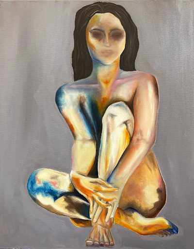 Photo of Fieldston Upper student painting portrait of a women sitting cross-legged.